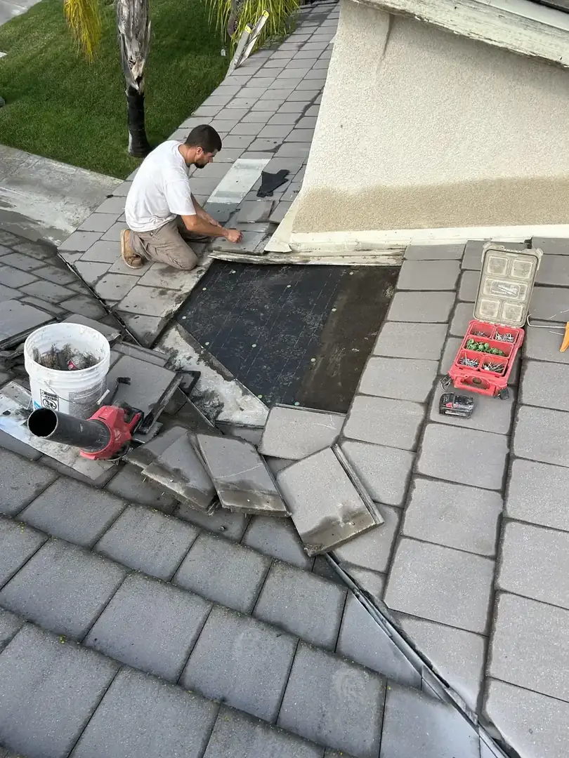 Roof repair work in progress on a tile roof