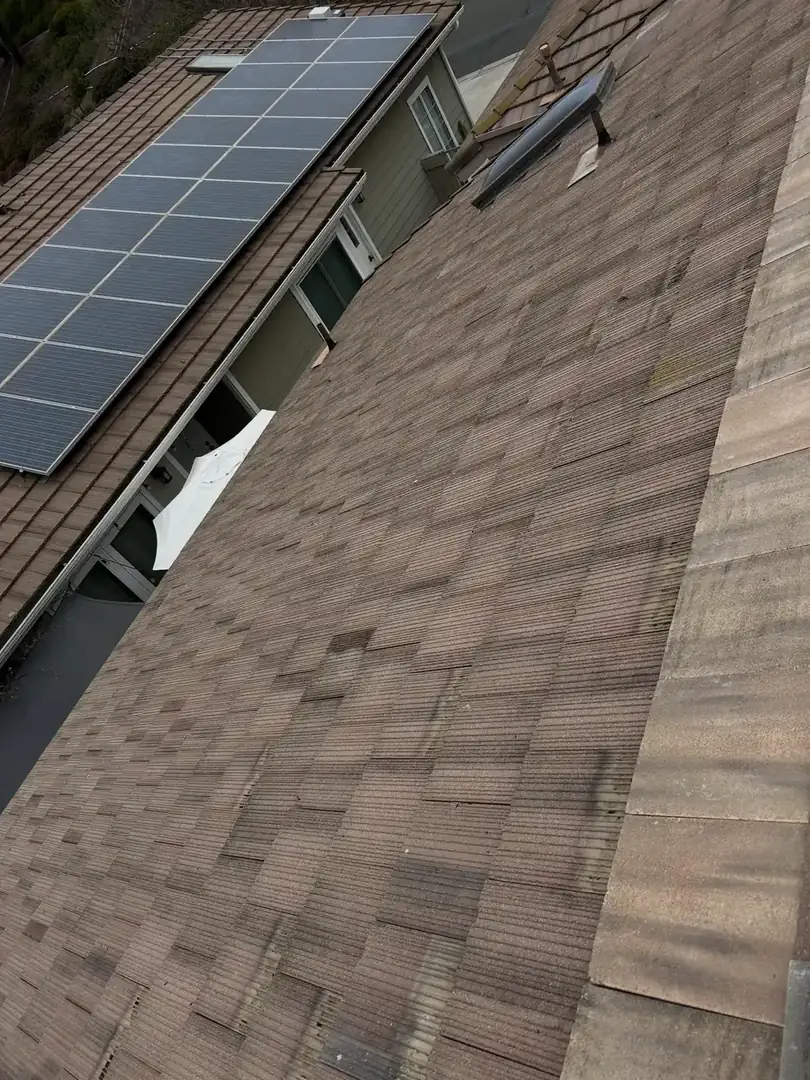 Roof repair specialist working on a tile roof in Wildomar, CA
